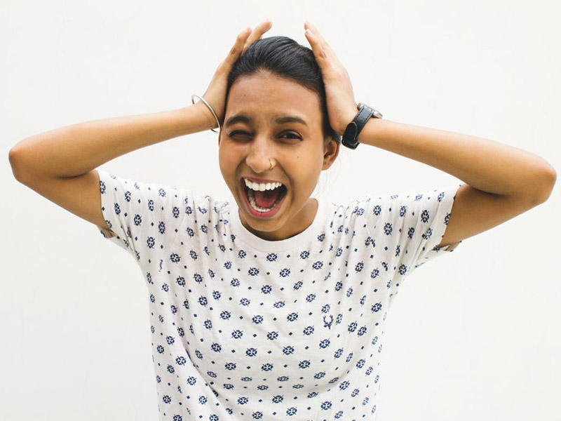 Woman putting her hands to her head in shock!