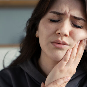 Woman suffering toothache while traveling