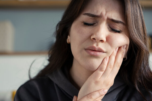Woman suffering toothache while traveling