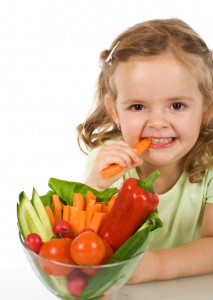 a kid eating vegetables