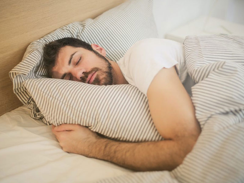 Man sleeping peacefully in bed.