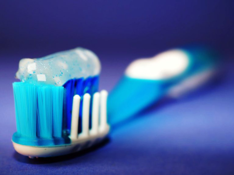 A toothbrush with toothpaste on it.