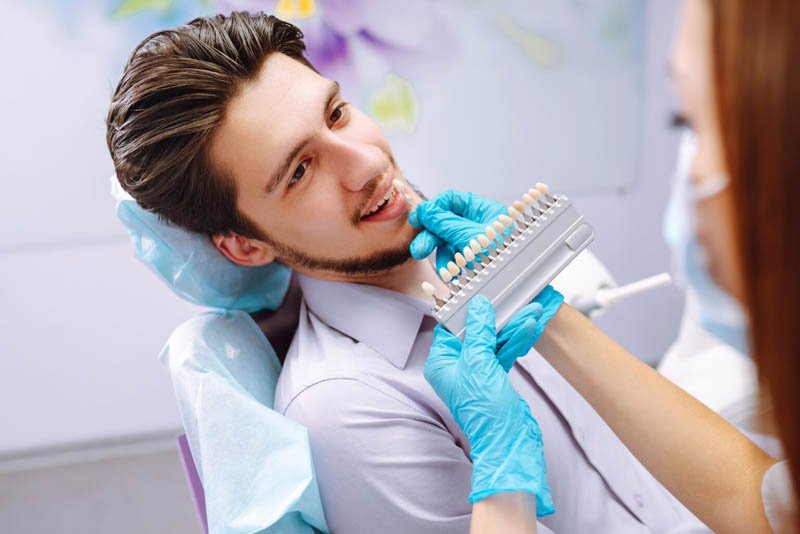 Young man at the dentist's chair during a dental procedure. Over